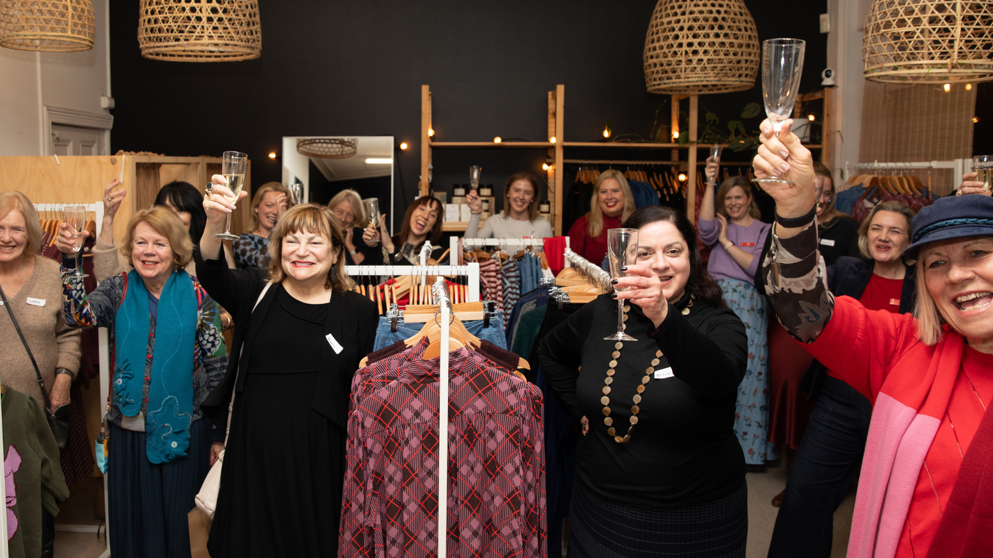 A group of women toasting champagne in a fashion store for the Frock Me Out x Dramatic Women x State Theatre Company South Australia Evening