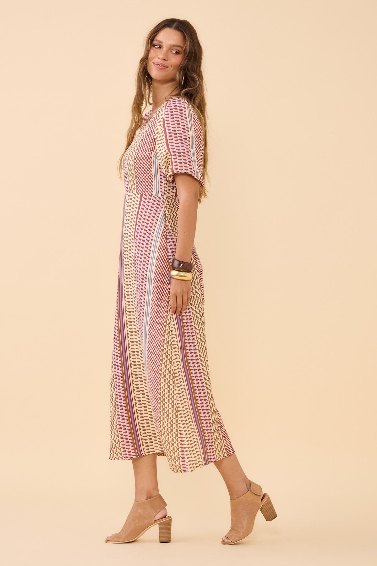 Woman wearing Frock Me Out Resort Mod Shapeshifter Dress standing on the side