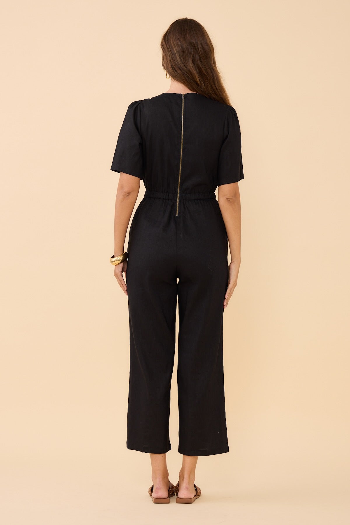 Woman standing wearing Frock Me Out BLACK V Neck Sleevie Wonder Jumpsuit