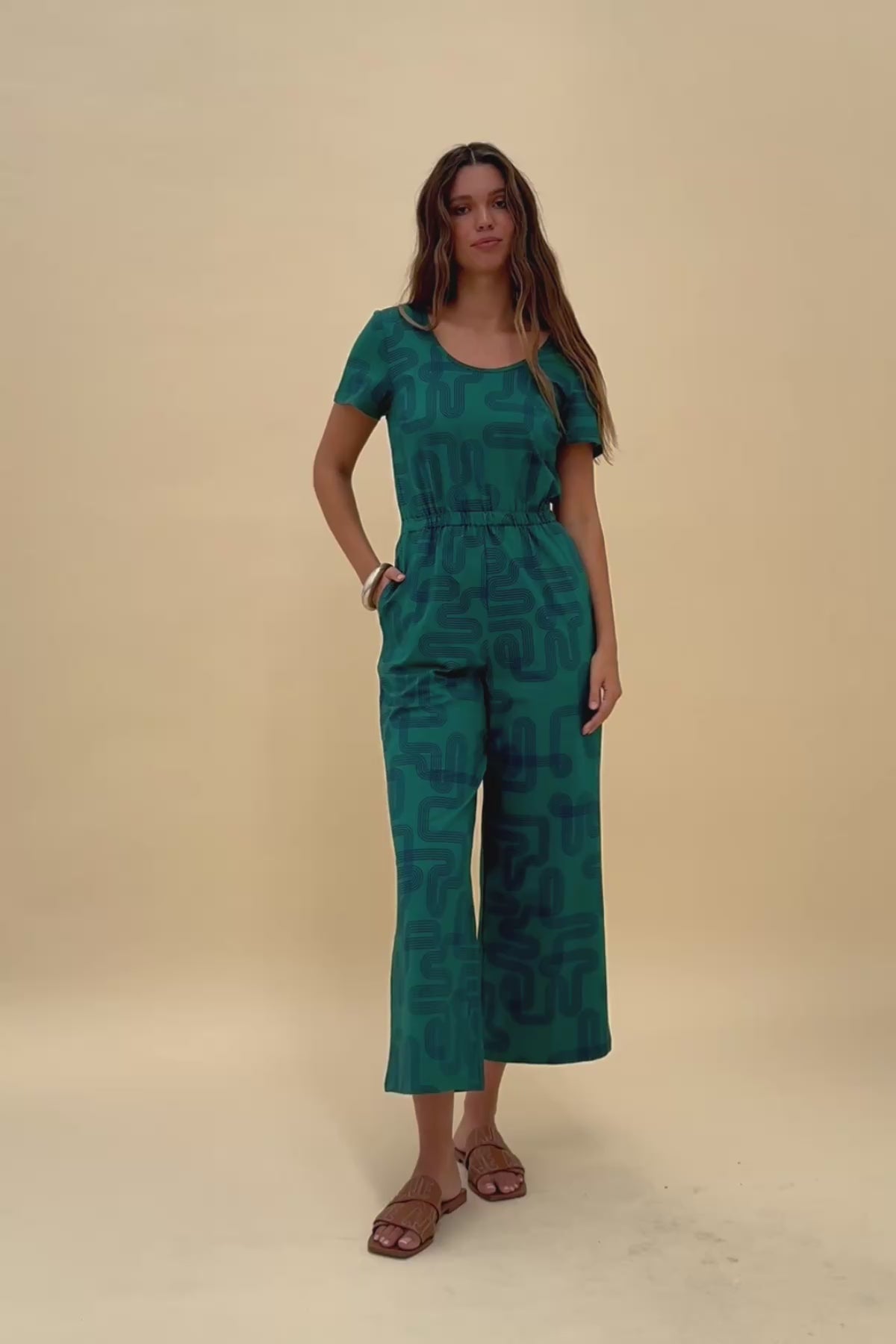 Woman twirling around wearing the Frock Me Out Labyrinth Stretch Jumpsuit
